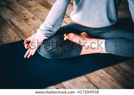 Young woman meditates while practicing yoga. Freedom concept. Calmness and relax, woman happiness.