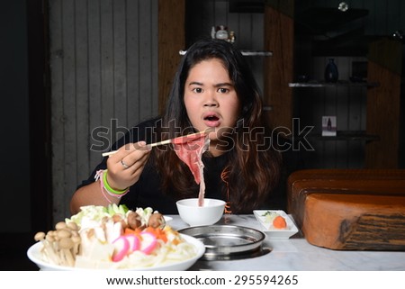 young woman eating meat