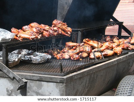 Turkey legs on a commercial barbecue at a summer festival.