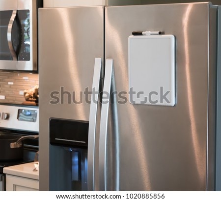 Stainless steel refrigerator with a magnetic dry erase whiteboard