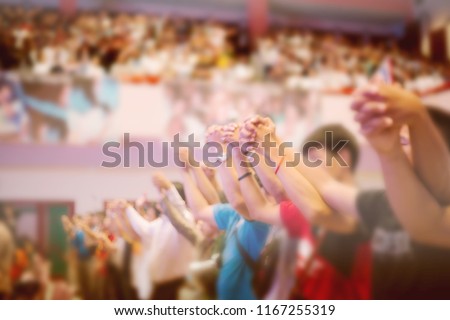 Soft focus of Christian worship with raised hand,music concert