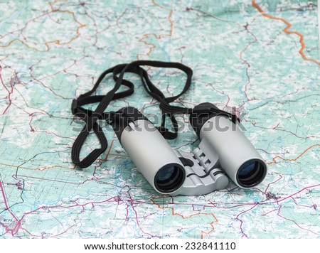 Binoculars on the map close-up. In search of treasure.