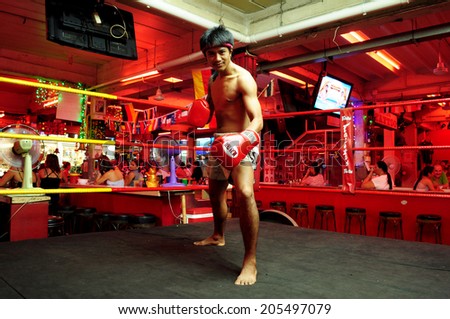 Pattaya, Thailand - circa July 2014 - an unidentified man shows Thai boxing on stage at walking street, Pattaya city, Thailand