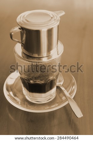 sepia tone of Vietnamese coffee , the traditional Vietnamese coffee brewing coffee by \