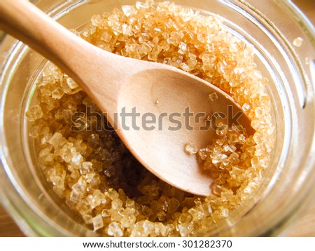 a wooden spoon in brown sugar jar