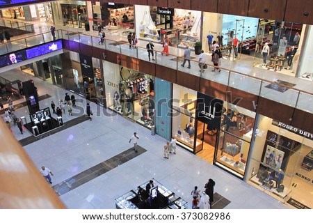 shopping center Dubai Mall, top view inside, boutiques and people make purchases, United Arab Emirates April 14, 2014, soft focus