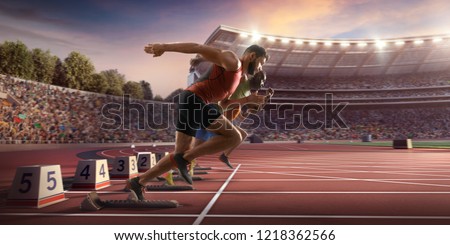 Male athletes sprinting. Two men in sport clothes run at the running track in professional stadium