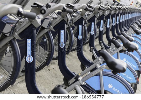 LONDON - MARCH 22: Row of hire bikes lined up in a docking station in London, on March 22, 2014. This bicycle sharing system was first introduced in London in July 2010.