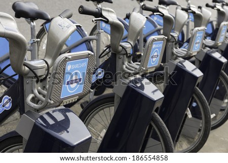 LONDON - MARCH 22: Row of hire bikes lined up in a docking station in London, on March 22, 2014. This bicycle sharing system was first introduced in London in July 2010.
