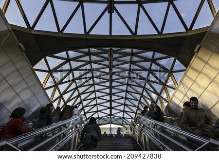 MADRID - DECEMBER 15: Commuters on escalator under the modern glass ceiling of Sol metro Station in the center of Madrid, Spain, on December 15, 2014.