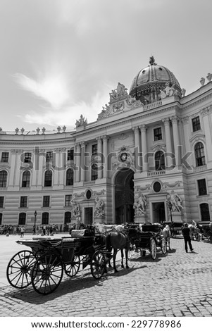 VIENNA - JUNE 23: Carriage horses (Fiakers) and their drivers wait for clients outside the Hofburg Complex in Vienna on a clear Summer morning, Austria, on June 23, 2014.