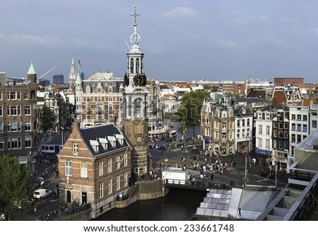 AMSTERDAM - SEPTEMBER 7: Eagle-eye view of the city on Amsterdam in the Netherlands on a cloudy morning, with the Munttoren near the flower market in the foreground, on September 7, 2014.