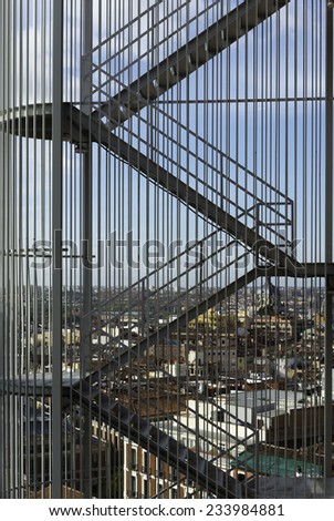 Aerial view of Madrid from North to South as seen through a metal staircase on top of one of the highest buildings in the city center.