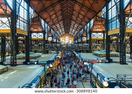 BUDAPEST, HUNGARY - JUNE 6: Wide-angle view of the central hall of the Great Market Hall in Budapest, Hungary, full of locals and tourist buying form the different stalls, on June 6, 2015.