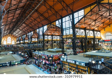 BUDAPEST, HUNGARY - JUNE 6: Wide-angle view of the central hall of the Great Market Hall in Budapest, Hungary, full of locals and tourist buying form the different stalls, on June 6, 2015.