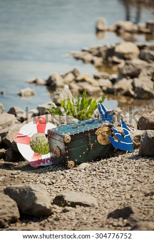 Marine decorations. Scene on sea beach. Treasure chest