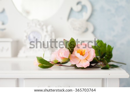 Tender tea rose on beautiful white dressing table