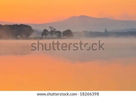 rising sun burns early morning mist from Lake Leane, Killarney, Co.Kerry, Ireland
