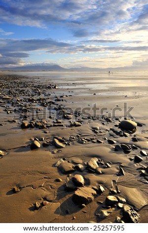 evening light shines on expansive beach at Ballyheige, Co.Kerry, Ireland