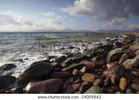 waves rush towards rocky shoreline, at Rossbeigh Strand on Dingle Peninsula, Co.Kerry, Ireland