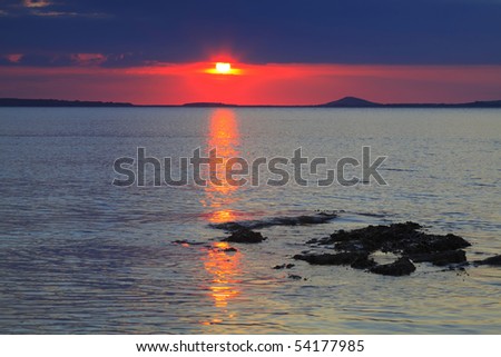 sun sinks to horizon on Irelands West Coast at Rosses Point, Co.Sligo, Ireland