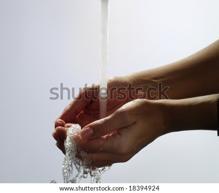 Water pouring into hand and splashing