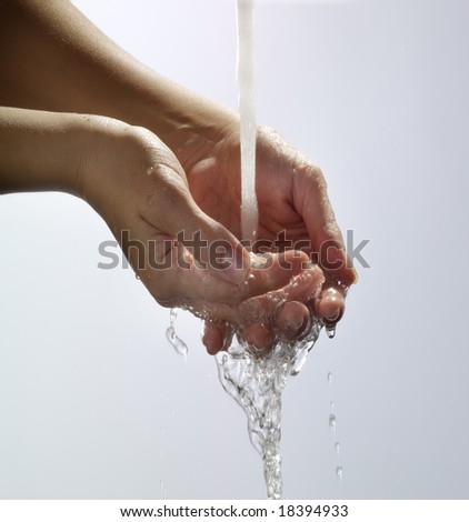 Water pouring into hand and splashing