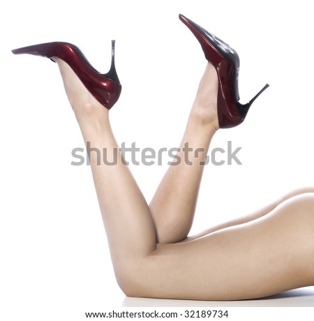 stock photo Beautiful legs in red shoes isolated on white background