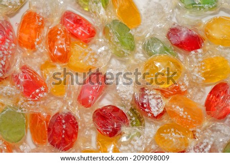Colorful candies in transparent wrappers closeup