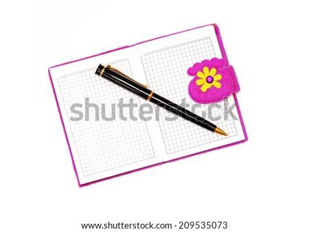 Open notebook in a purple cover with a black ballpoint pen on a white background