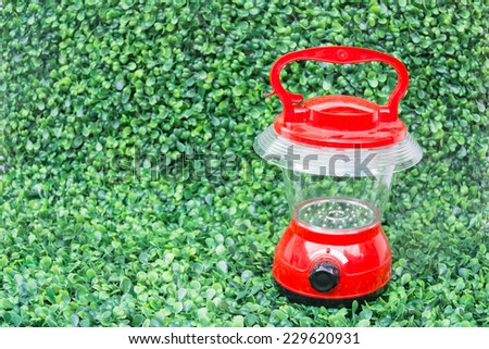 Red Led lantern  for tourist tent on green grass background