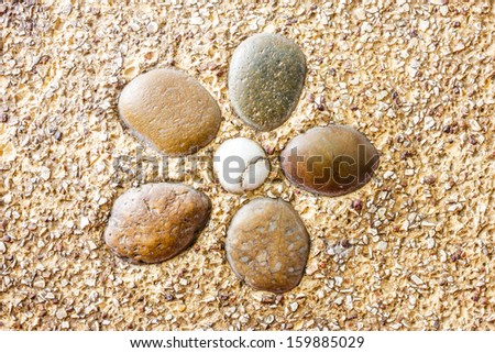 Wet round stone rock texture with tiny water drops on them and dramatic lighting.