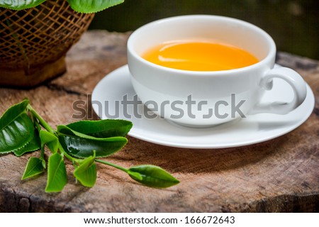 a cup of green tea on wood board, drink for health