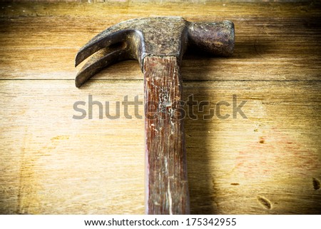 Hammer head  on a wooden panel with space for text