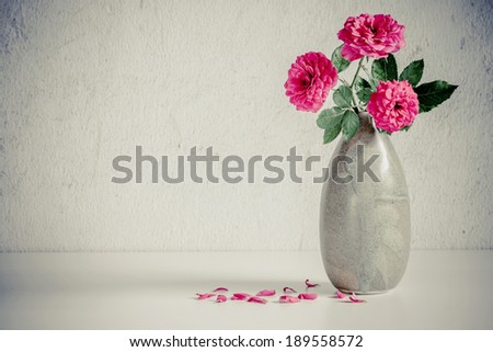 Still life with pink roses flower in ceramic vase