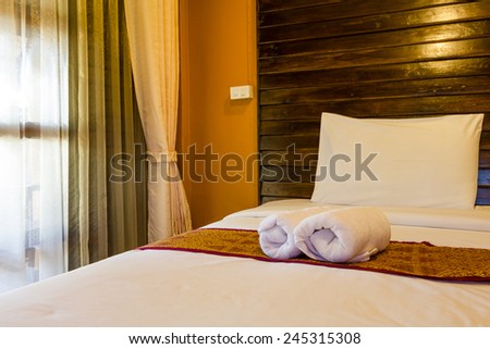 Towel in Hotel Room, Bedroom ready for guests in soft warm lighting