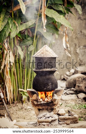 Pot boiling water for cooking sticky rice on the fired stove. Thai food