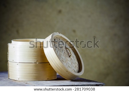 Bamboo round container shape for steaming asian food, Japanese Chinese Vietnamese on brown background