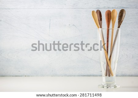 kitchen utensils, wooden spoons on white wooden background