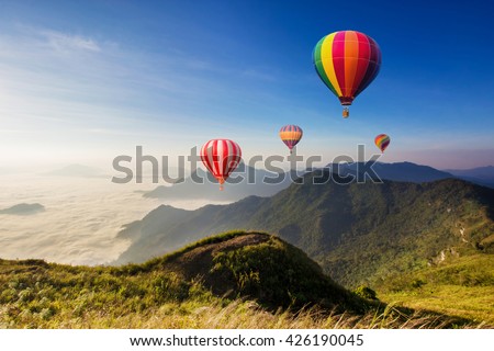 Colourful hot-air balloons flying over the mountain at Phucheefa,Chiangrai province ,North of Thailand.