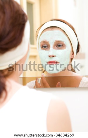 Woman in bathroom with beauty mask