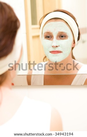 Woman in bathroom with beauty mask
