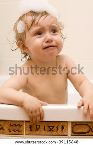 stock photo Crying baby girl in bath