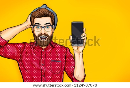 Attractive smiling hipster in specs with phone in the hand in comic style. Pop art man in hat holding smartphone. Digital advertisement male model showing the message or new app on cellphone.
