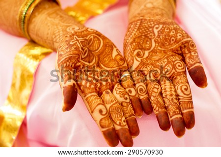 Mehendi (henna) used to decorate the palms of a woman in a pink saree. Mehendi is widely used in India and Pakistan during occassions like Diwali or Eid
