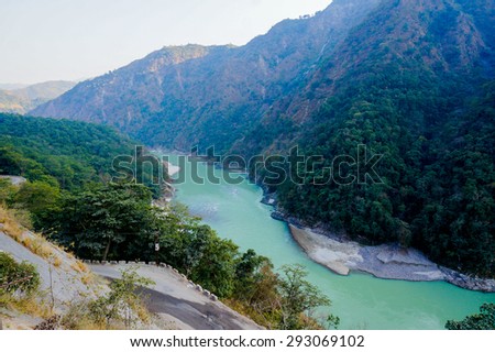 Himalya mountain range with the Ganges flowing through it. This is further up in the mountains from Rishikesh and is a popular tourist destination