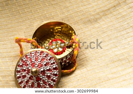 Rakhi thread packaged in a beautiful golden and red box. These are sent by sisters to their brother as a sybol of love