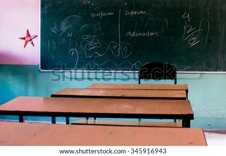 Wooden school benches facing a blackboard. Typical scene in a rural or small town school in India