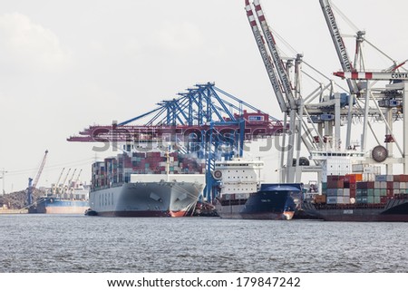 Hamburg, Germany - july 5: Giant ship in container harbor with tall cranes in Hamburg Harbor, Germany on july 5, 2013