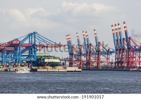 HAMBURG - JULY 5: Container ship in container harbor with tall cranes in Hamburg Harbor, Germany on July 5, 2013